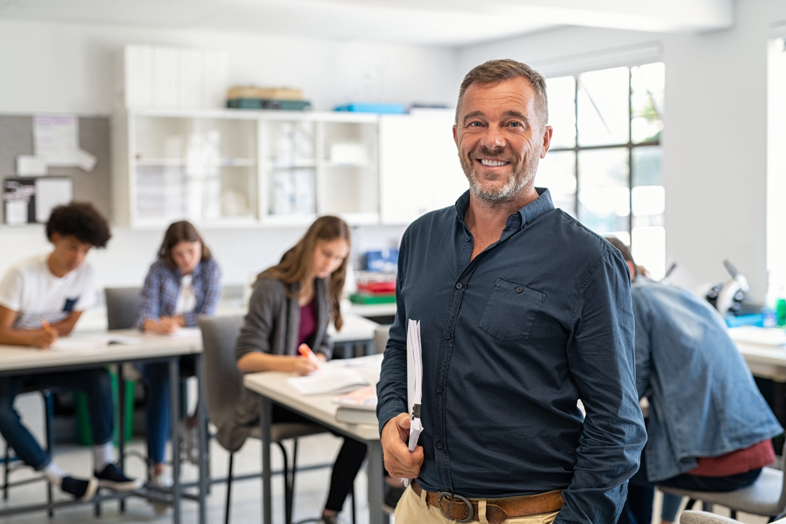 Male educator standing at the top of the classroom